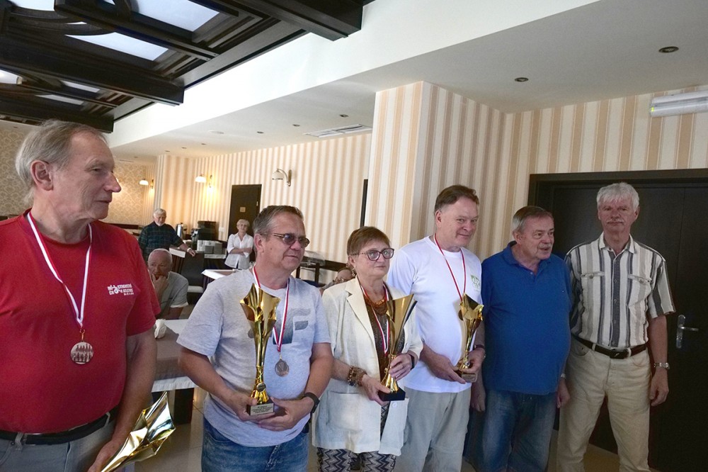 grupa osób z pucharami i medalami