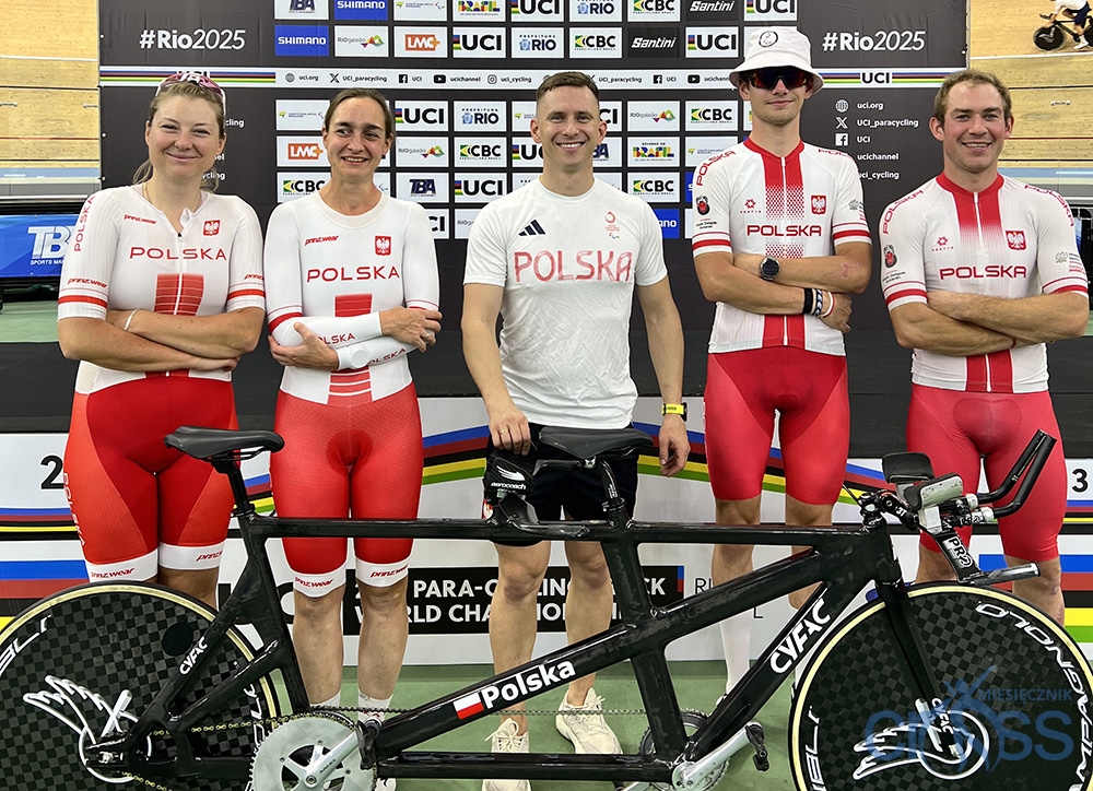 grupa os&oacute;b stoi przy rowerze